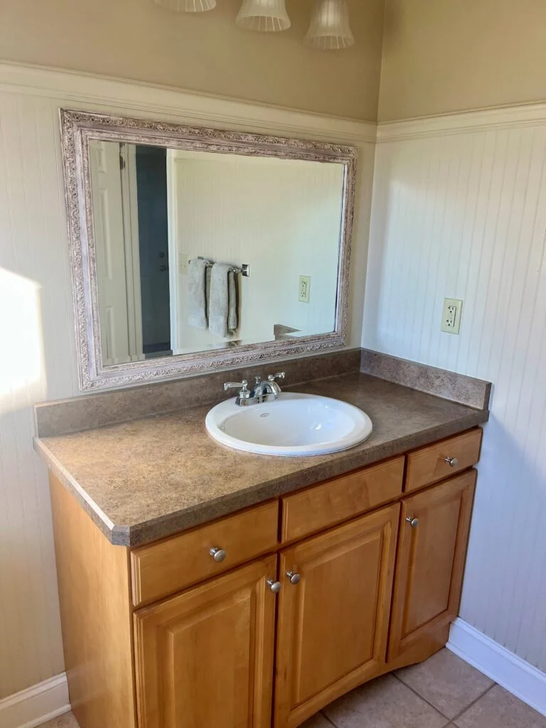 Before and after vanity mirror and countertop remodel in Austin